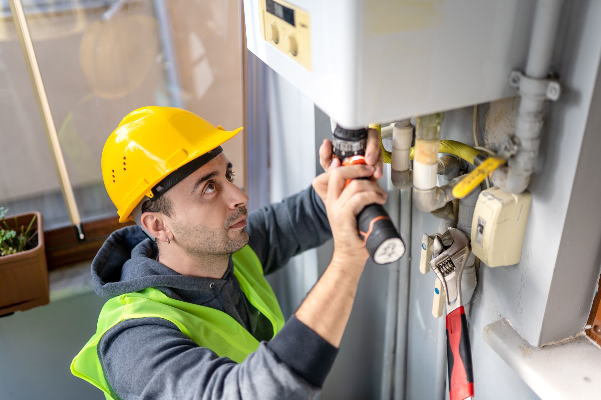 Private technician repairing combi gas boiler
